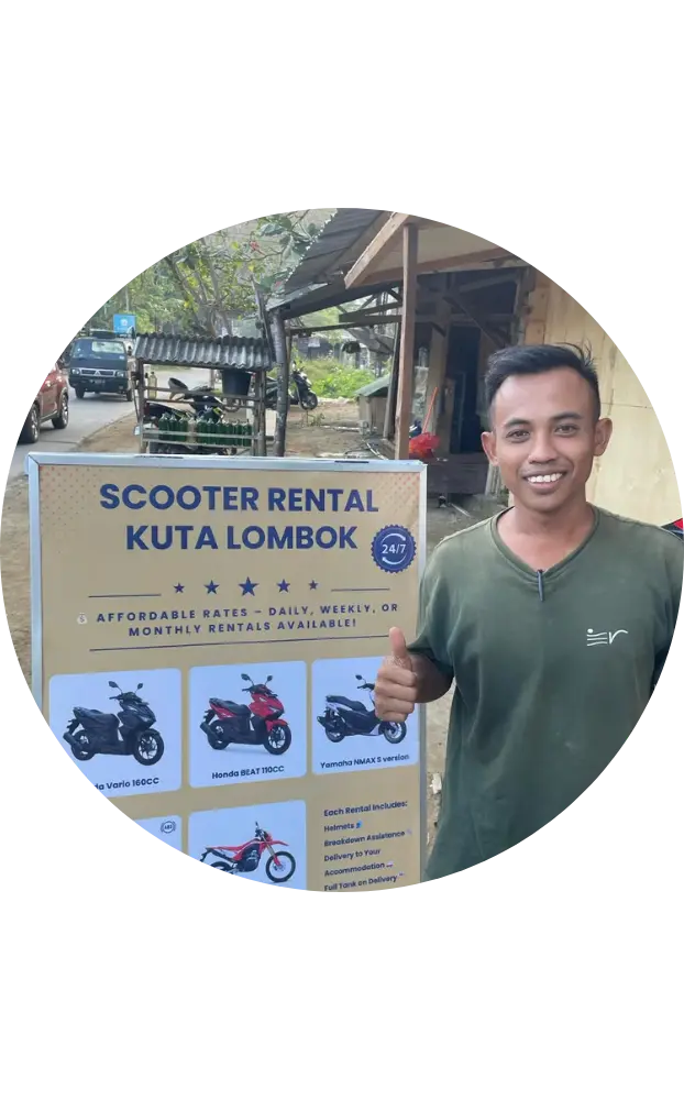 The owner of go moh in front of the shop